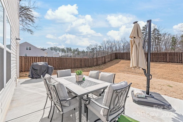 view of patio with outdoor dining space and a fenced backyard