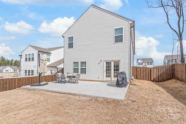 back of house featuring a patio area, a fenced backyard, and a lawn