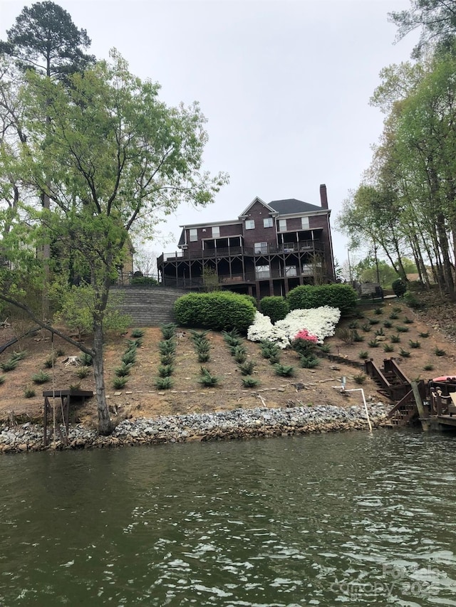 back of house with a water view