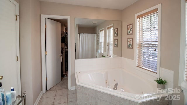 full bath featuring tile patterned flooring, a walk in closet, a jetted tub, and curtained shower