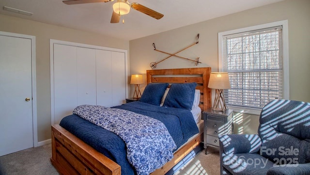 bedroom featuring visible vents, a closet, a ceiling fan, and carpet flooring