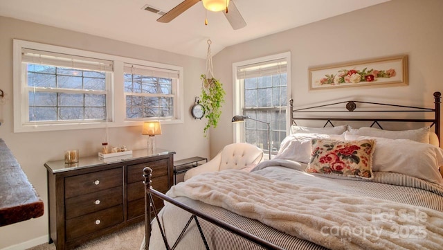 bedroom featuring vaulted ceiling, carpet flooring, visible vents, and a ceiling fan