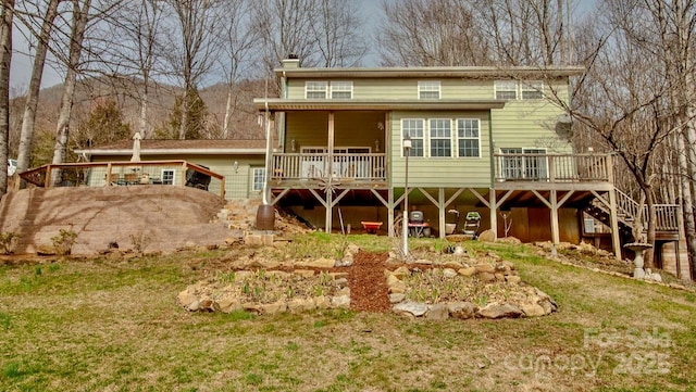 back of property with a chimney and a wooden deck