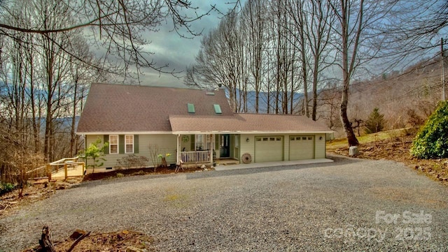 view of front of home featuring a garage, a shingled roof, crawl space, gravel driveway, and a porch