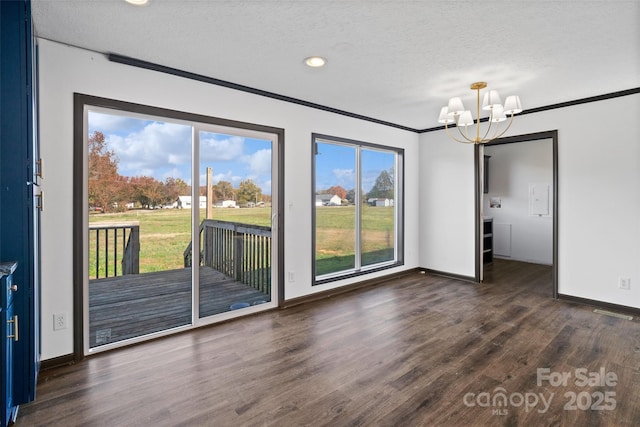 interior space with dark hardwood / wood-style flooring, crown molding, a textured ceiling, and an inviting chandelier