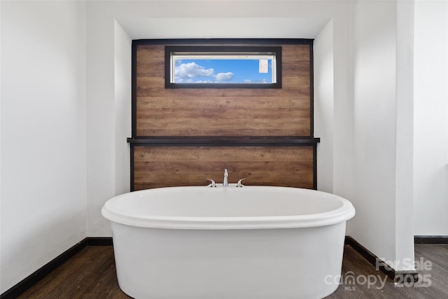 bathroom featuring a bath and hardwood / wood-style floors