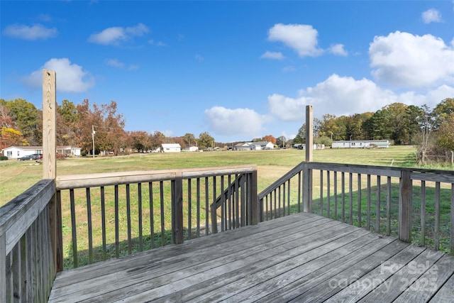 wooden deck featuring a lawn