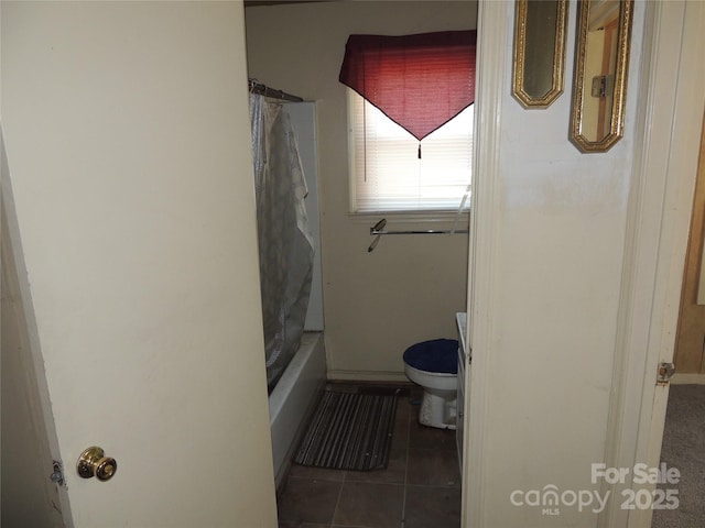 bathroom with tile patterned floors, toilet, and shower / bath combination with curtain