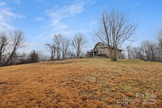 view of yard featuring a rural view and a deck