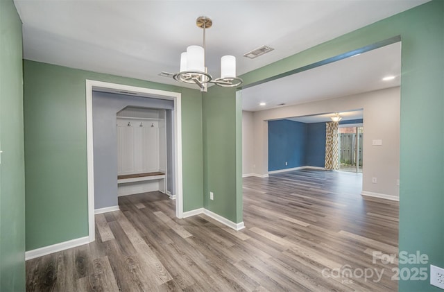 unfurnished dining area with hardwood / wood-style flooring and an inviting chandelier