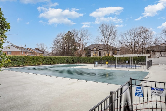 view of swimming pool with a patio area and a pergola