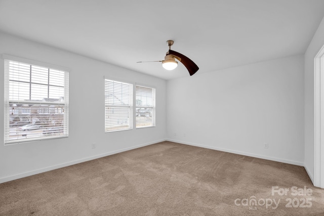 carpeted spare room with ceiling fan