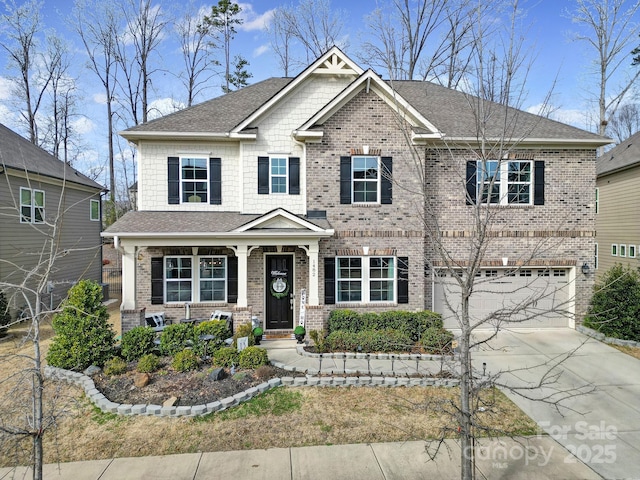 craftsman-style house featuring concrete driveway, brick siding, an attached garage, and roof with shingles