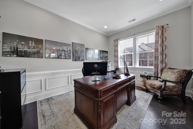 office space featuring a wainscoted wall, crown molding, visible vents, a decorative wall, and wood finished floors