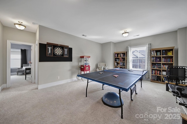 rec room featuring baseboards, visible vents, and light colored carpet