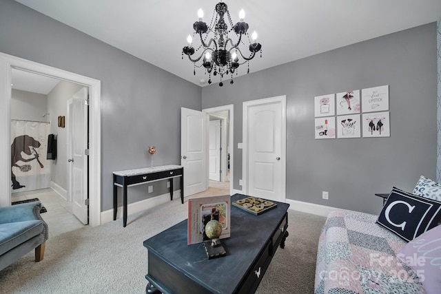 carpeted living area featuring an inviting chandelier and baseboards