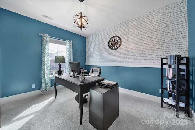 carpeted office space with a chandelier, an accent wall, visible vents, and baseboards