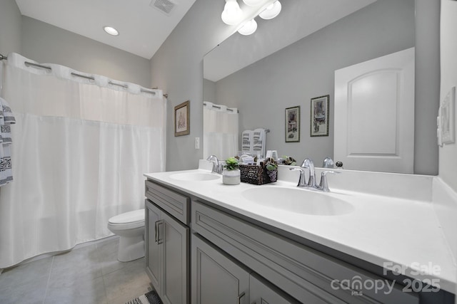 full bath with toilet, a sink, visible vents, and tile patterned floors