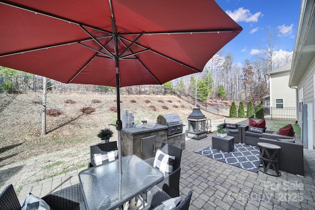 view of patio featuring outdoor dining area, a fenced backyard, an outdoor living space, exterior kitchen, and grilling area