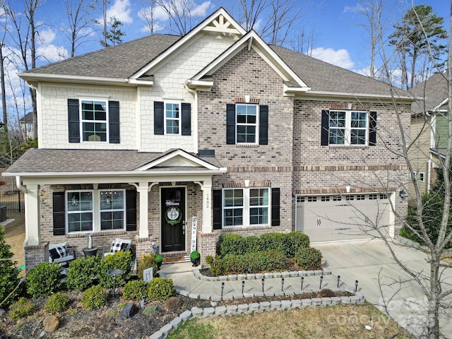 craftsman house featuring a garage, concrete driveway, brick siding, and roof with shingles