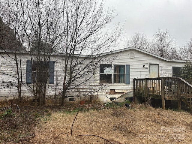 back of property featuring a deck