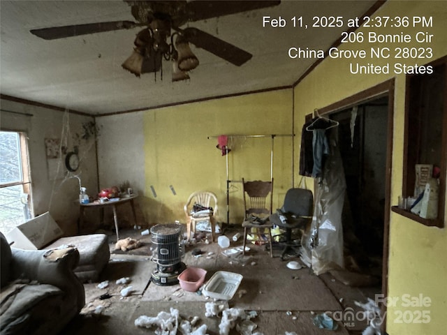 miscellaneous room with ornamental molding and ceiling fan