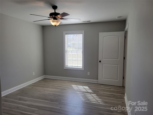 unfurnished room featuring hardwood / wood-style flooring and ceiling fan