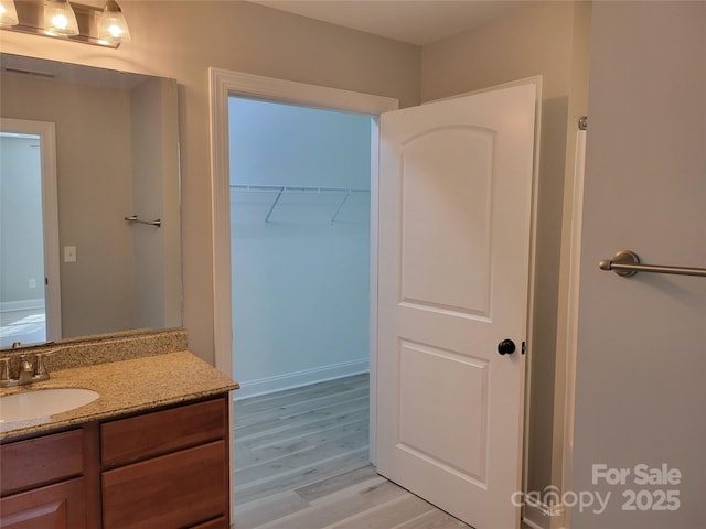 bathroom featuring hardwood / wood-style flooring and vanity