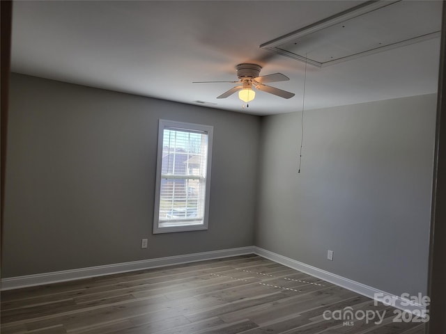 spare room featuring ceiling fan and dark hardwood / wood-style floors