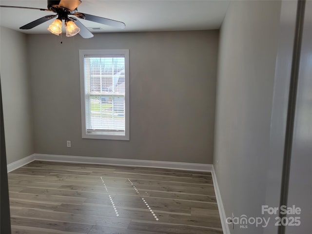 spare room with hardwood / wood-style flooring and ceiling fan