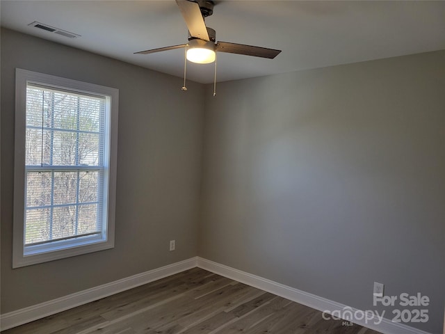 unfurnished room with ceiling fan and dark hardwood / wood-style floors