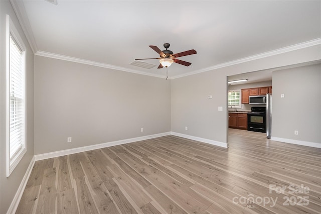 spare room featuring baseboards, light wood-style flooring, and ceiling fan