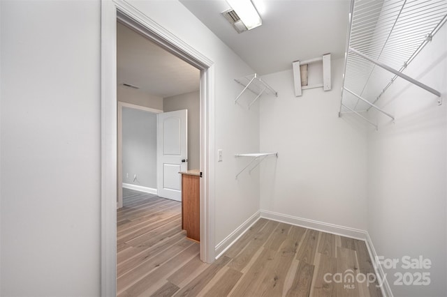 walk in closet with light wood-style floors and visible vents