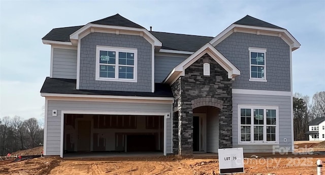 view of front facade with stone siding and an attached garage