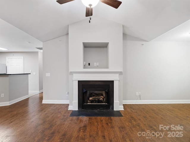 unfurnished living room with lofted ceiling, a fireplace with flush hearth, a ceiling fan, wood finished floors, and baseboards