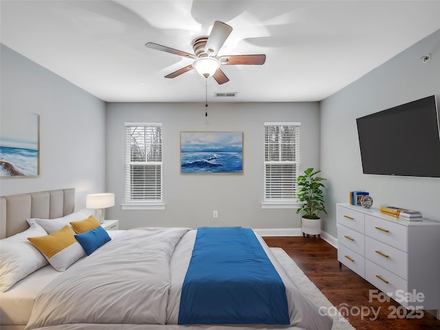 bedroom with baseboards, visible vents, ceiling fan, and dark wood-style flooring