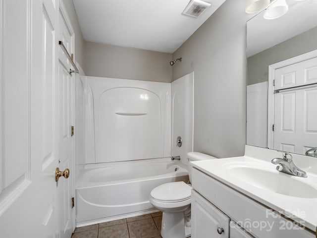 bathroom featuring toilet, vanity, visible vents, tile patterned floors, and washtub / shower combination