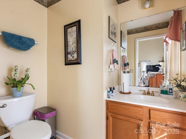 bathroom featuring vanity and toilet