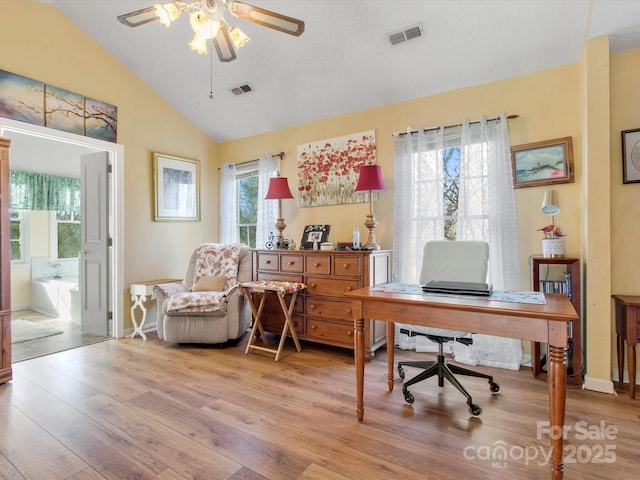 office space featuring vaulted ceiling, light hardwood / wood-style floors, and ceiling fan