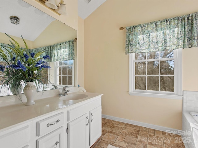 bathroom featuring vanity and vaulted ceiling