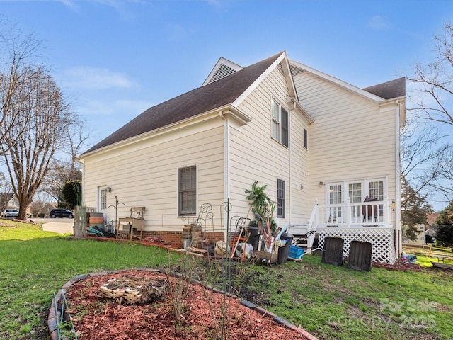 view of side of home with a lawn