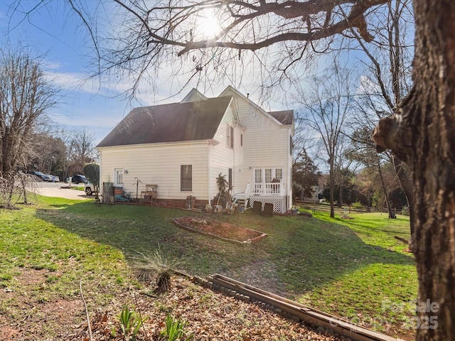 view of property exterior with a yard