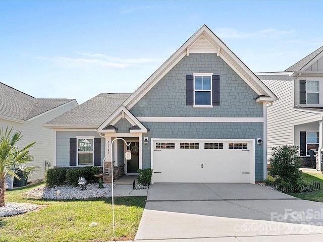 view of front of property with a garage and a front yard