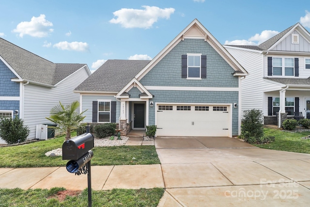 craftsman-style house featuring a garage and a front yard