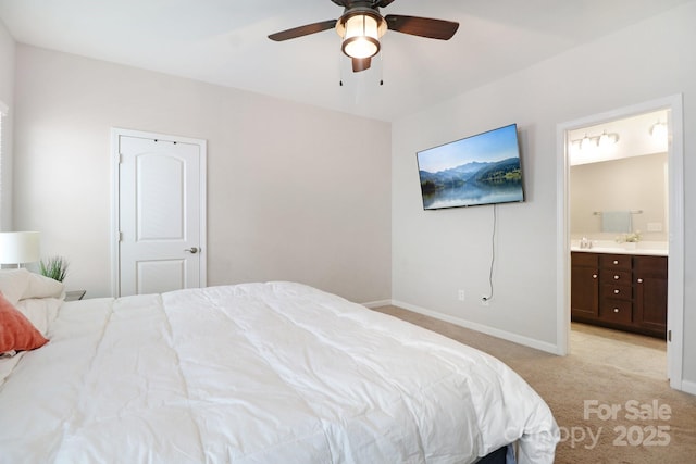 carpeted bedroom with connected bathroom and ceiling fan