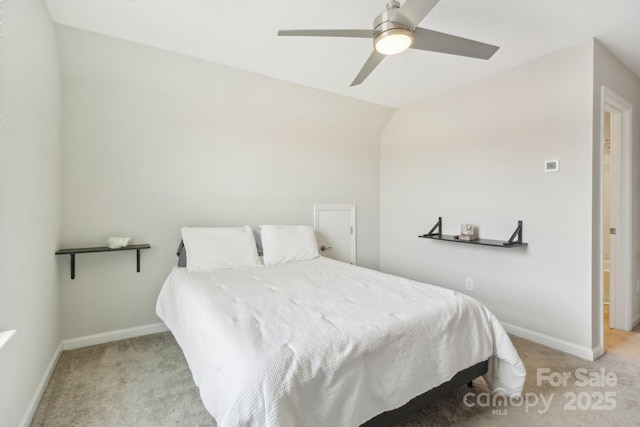 bedroom featuring light carpet, vaulted ceiling, and ceiling fan