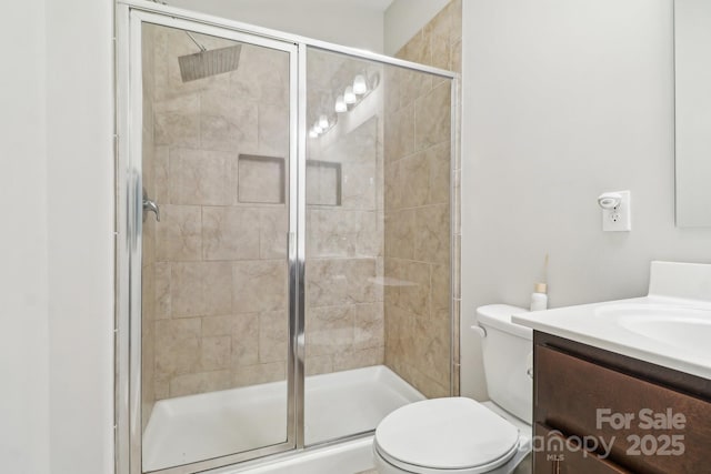 bathroom with vanity, toilet, and walk in shower