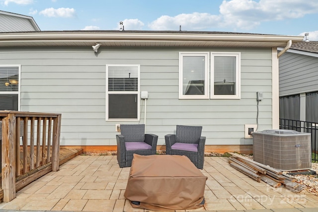 back of property featuring central AC unit and a patio area