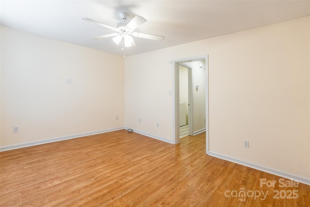 spare room with ceiling fan and light wood-type flooring