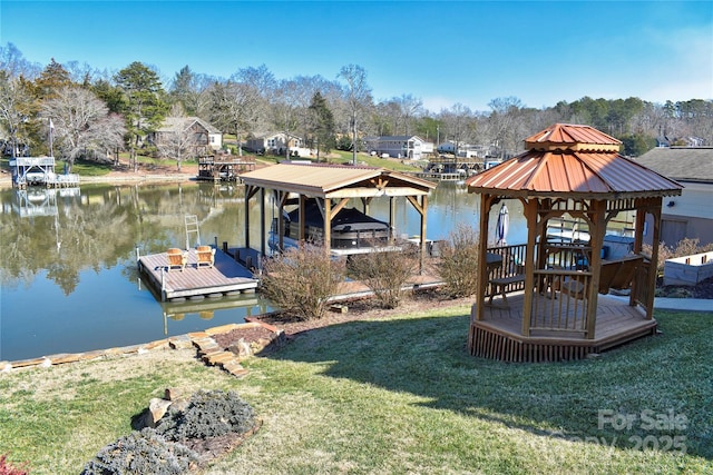 dock area featuring a gazebo, a yard, and a water view